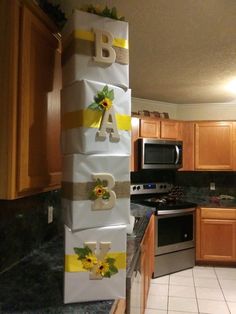 a stack of wrapped presents sitting on top of a kitchen counter