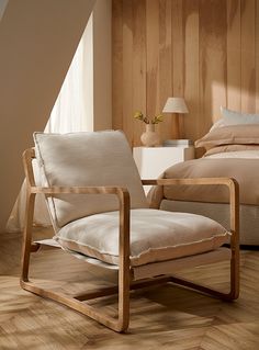 a chair sitting on top of a wooden floor next to a bed