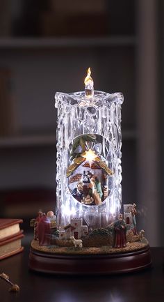 an illuminated nativity scene on top of a table