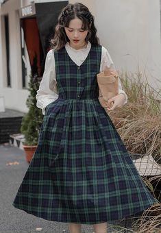 V-neck plaid pinafore dress with a button front, side pockets, adjustable back ties and pleated midi swing skirt. S: 34.5" chest, 42" lengthM: 36" chest, 42" lengthL: 37.5" chest, 42.5" lengthXL: 39" chest, 42.5" length Casual Plaid V-neck Dress, Casual V-neck Plaid Dress, Casual A-line Plaid Dress, Casual Plaid V-neck Midi Dress, Casual Plaid Midi Dress For Work, Casual Cotton Plaid Dress With V-neck, Casual Plaid Cotton V-neck Dress, Casual Plaid Dresses With Pockets, Fall Plaid Cotton Midi Dress