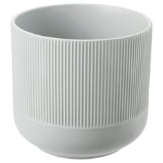 a white bowl with lines on the bottom and sides, sitting in front of a white background