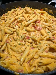 a skillet filled with macaroni and cheese covered in sauce