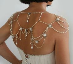 the back of a woman's dress with pearls on it