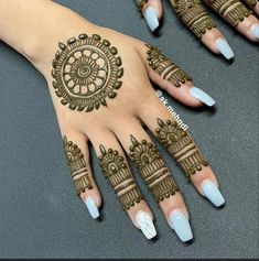 two hands with henna tattoos on them