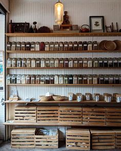 the shelves are filled with jars and baskets