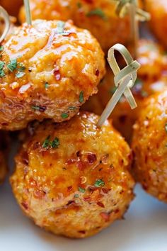 some meatballs with toothpicks on top of them are ready to be eaten