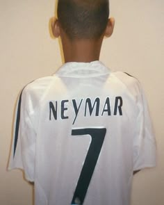 the back of a young man's soccer jersey, which reads neymar 7