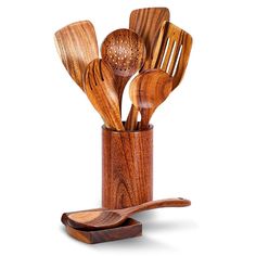 a wooden utensil holder with spoons and spatulas in it on a white background