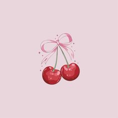 two cherries with a pink bow on top