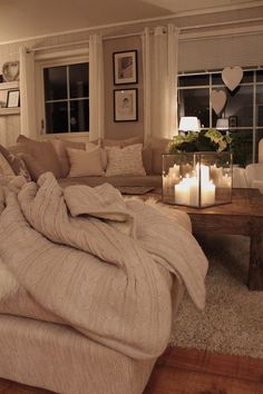 a living room filled with furniture and candles