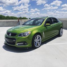 a green car parked in a parking lot