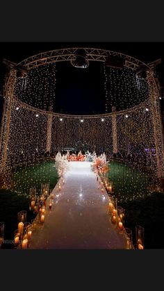 an outdoor wedding venue decorated with candles and lights