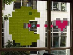 a window that has some sticky notes on the outside of it and an image of a green apple