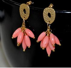 Shop Coral Drop Earrings Gold. These beautiful Pink Coral Dangle Earrings are so versatile and classically festive and fun. Dangle studs will be gorgeous with that little black dress, a wedding gown, jeans, or just about anything! They are made from: - Beautiful pink/salmon coral rice shape beads - Gold plated textured ovals with sterling silver posts - Gold filled chain and gold filled oval jump rings Gold stud earrings are a little over 1.5" long. Coral earrings will make a great gift for those who love Bohemian Jewelry.  Your order will arrive in a nice pouch ready to be given. Your order of handmade jewelry will be mailed within 2 business days.  All US orders and most international orders will have tracking#. To see more of my jewelry: https://www.etsy.com/shop/naturalstonesjewels Coral Drop Earrings, Casual Earrings, Tiny Hoop Earrings, Light Earrings, Rice Bead, Coral And Gold, Coral Earrings, Coral Jewelry, Gold Stud Earrings