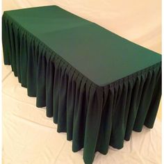 a green table with pleated cloth on it