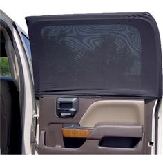 an open car door with the back window covered in a black cloth and wood trim