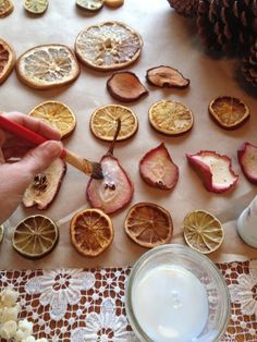 an image of someone cutting up fruit with a knife and some other things on the table