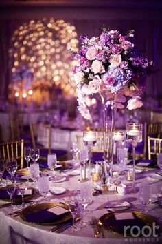 an elegant table setting with purple flowers and candles