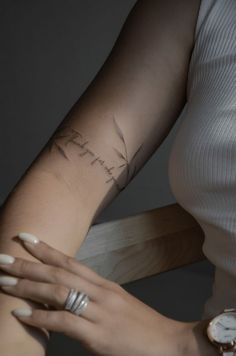 a woman's arm with a tattoo on it