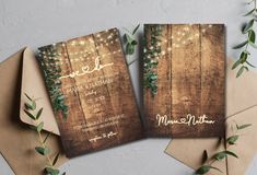 two wedding cards with lights and greenery on them