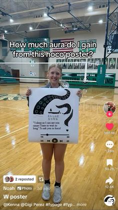 a woman holding up a sign in front of her face on a basketball court with the caption how much auria do i gain from this infocoposter?