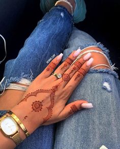 a woman with henna on her hand and wrist