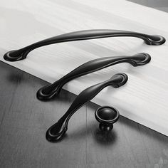 two black handles on a white counter top