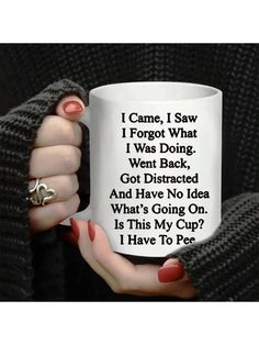 a woman holding a white coffee mug in her hands with the words i came, i saw