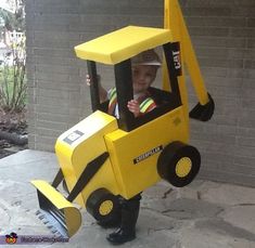 a small child in a construction vehicle costume