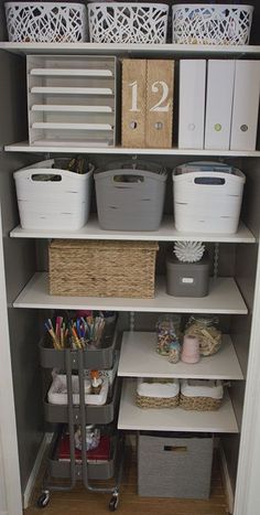 an organized closet with bins and baskets