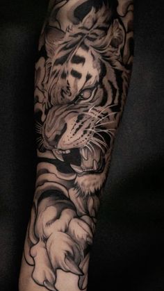 a man with a tiger tattoo on his arm