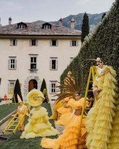 some people are dressed in yellow dresses and hats