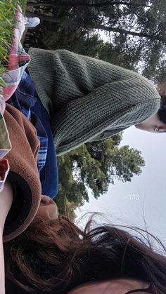 a woman is holding up her cell phone to take a selfie