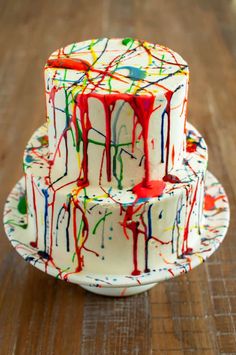 a three tiered cake covered in melted paint