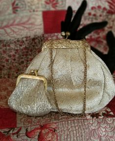 Beautiful petite gold brocade evening purse.  Ornate gold tone metal frame with a short chain.  Crystal kiss closure.   It comes with a small coin purse that nestles inside.  Creamy white inner lining with one small pocket.  Measures 6" wide x 5" tall.  Very chic look. Lenox Christmas Ornaments, Small Coin Purse, Black And White Tweed, Gold Brocade, Evening Purse, Very Merry Christmas, Vintage Victorian, Victorian Style, Creamy White