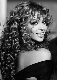 a black and white photo of a woman with curly hair