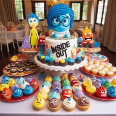 a table topped with lots of cupcakes and cakes