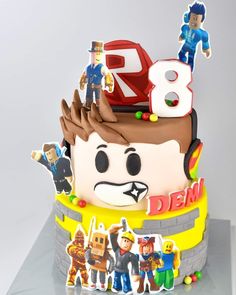 a birthday cake with the number eight on it's top and people around it