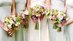 the bridesmaids are holding their bouquets together