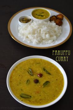 two white bowls filled with curry and rice on top of a wooden table next to each other