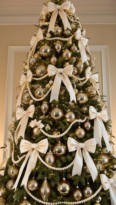 a christmas tree decorated with ornaments and bows