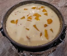 a pan filled with food sitting on top of a wooden table