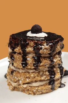 a stack of pancakes covered in chocolate syrup