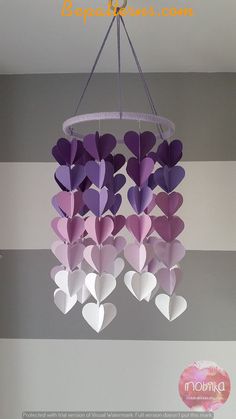 some paper hearts hanging from a chandelier