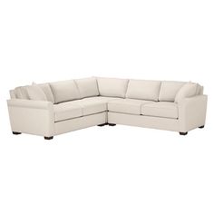 a white sectional couch sitting on top of a white floor