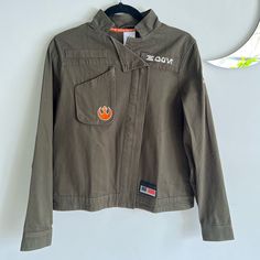 a jacket hanging up on a wall next to a hanger