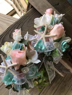 two bouquets with flowers and seashells on them