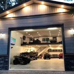 a garage with two cars in it and lights on the side of the garage door