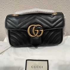 Gg Marmont Matelasse Mini Handbag. Ordered It A Few Months Ago And Have Never Used It. The Sliding Chain Strap Is Still Wrapped. Could Be Used As A Crossbody Or Shoulder Bag. Comes With Everything In The Pictures. Box Not Included. Classic Gucci Shoulder Bag With Gold-tone Logo Plaque, Gucci Rectangular Bag With Gold-tone Logo Plaque, Gucci Rectangular Shoulder Bag With Gold-tone Logo, Classic Gucci Bags With Gold-tone Logo Plaque, Elegant Gucci Bag With Gold-tone Logo Plaque, Gold Gucci Party Bag, Gucci Party Bags With Gold-tone Hardware, Gucci Leather Party Bag, Trendy Gucci Evening Bags