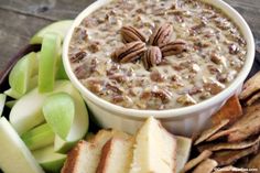 a white bowl filled with oatmeal next to sliced apples and crackers